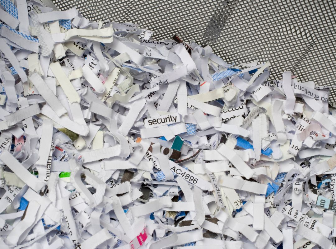 a pile of shredded papers with numbers on them